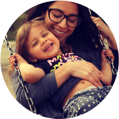 Girl on Swing with Mom Hugging Her